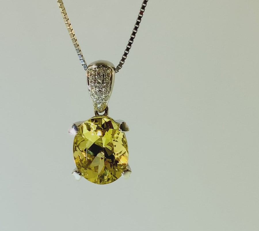 Oval Pendant with seventeen diamonds and heart shaped prongs